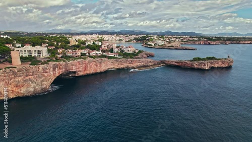 Beautiful view of coastal Porto Cristo village from above on Majorca Island. Torre del Serral dels Falcons by Drach Caves in Balearic Islands, Spain. photo
