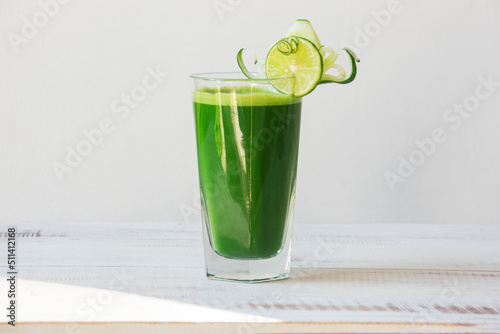 glass with celery green juice on white background