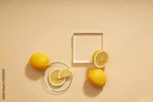 Top view of lemon decorated with transparent podium and green leaf blank space for advertising  photo