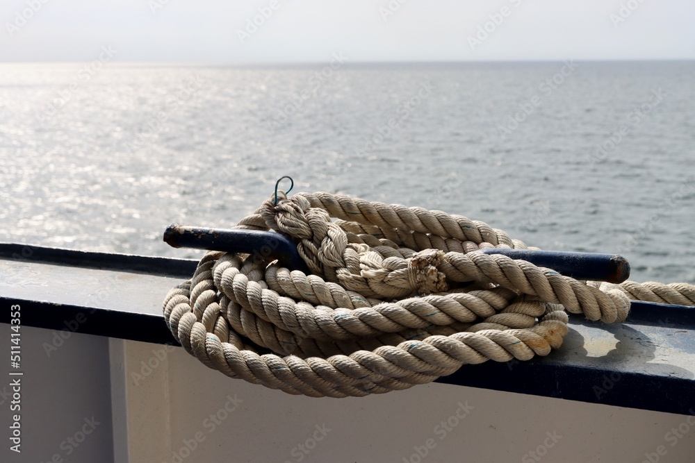 Coil of thick white rope aboard ship, close up