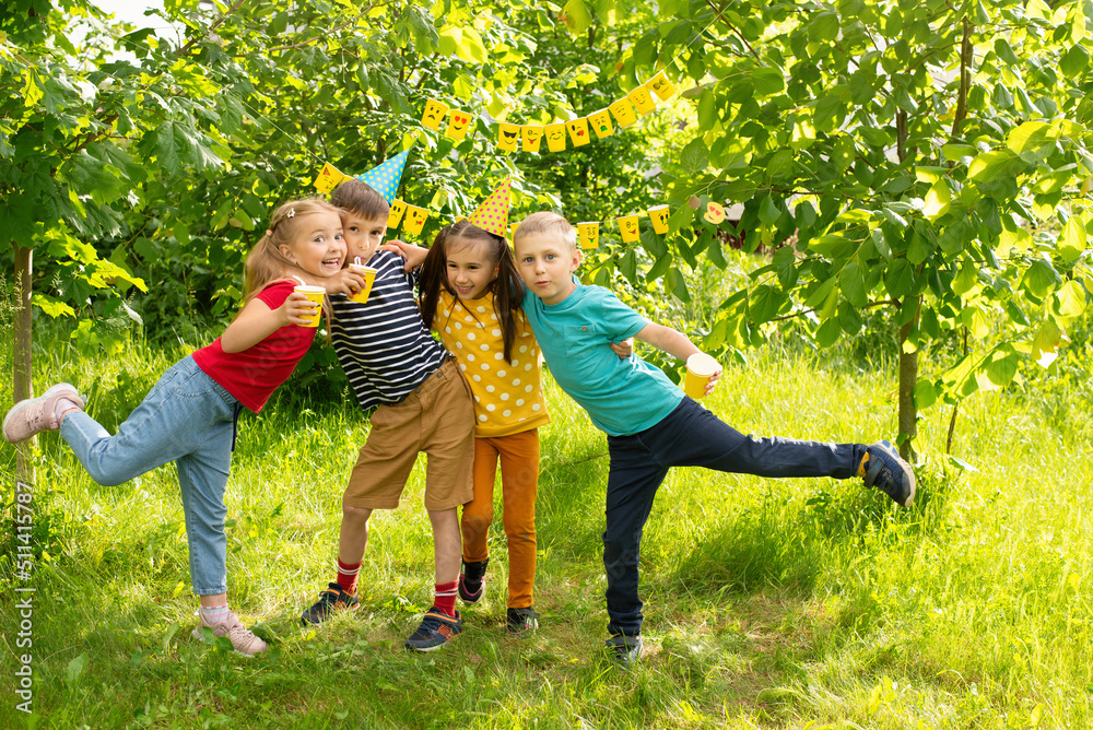 World Smile Day and a children's holiday, children have fun at a picnic in the summer,a cheerful company of children show emojis World Smile Day and a children's holiday, children have fun at a picnic in the summer,a cheerful company of children show emojis