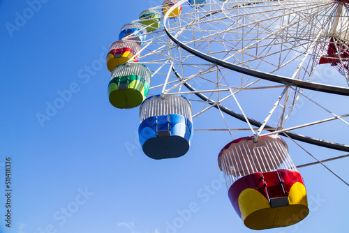 Colourful ferris wheel against a blue sky photo