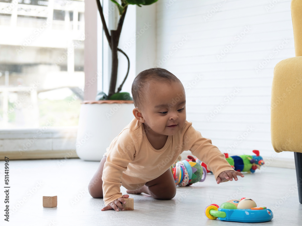 Cute little African baby crawling around the room to get colorful toys. Cute little African baby crawling around the room to get colorful toys.