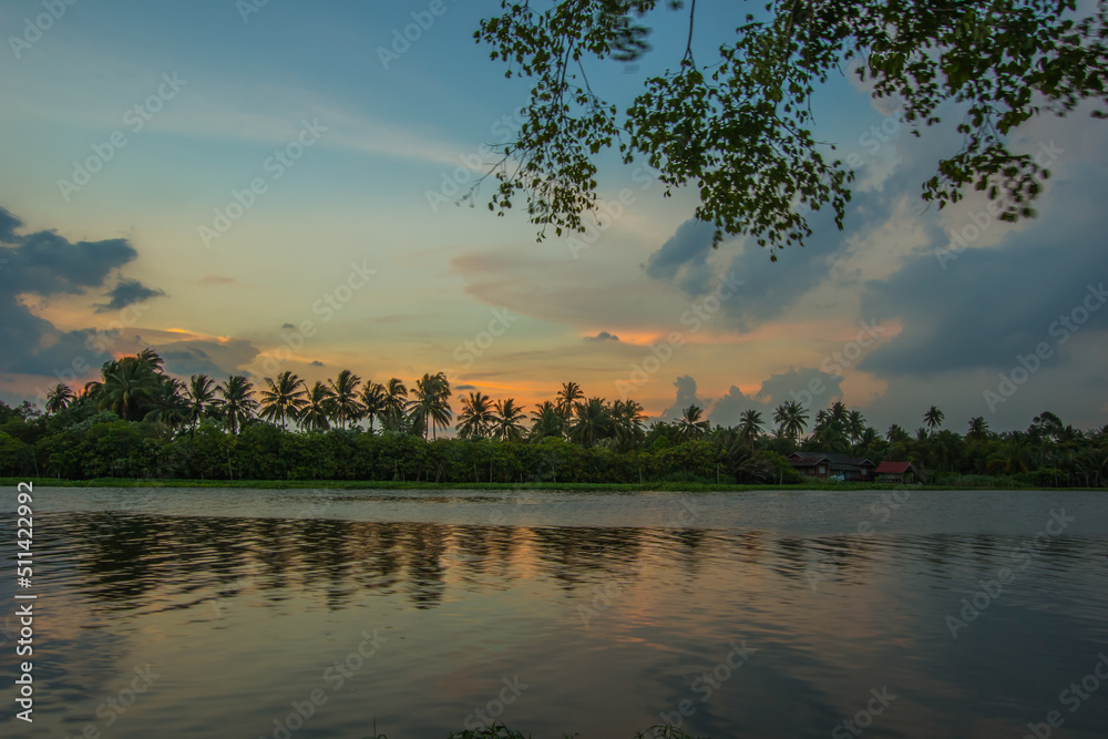 Naklejka premium Overcast sky during sunset along Tha Chin river(Maenam Tha Chin),Nakhon Pathom,Thailand