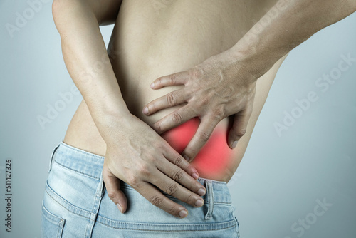 man having back pain lumbar pain He put his hand on his back. at the back pain point He showed signs of being unhappy.