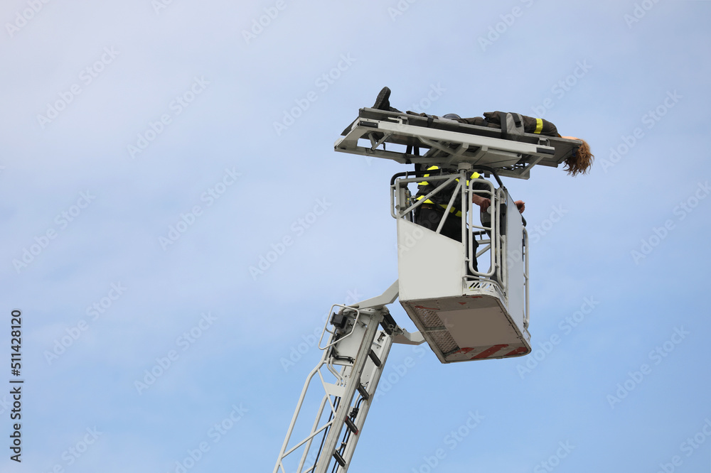 Firefighter on the aerial platform and the injured person Firefighter on the aerial platform and the injured person