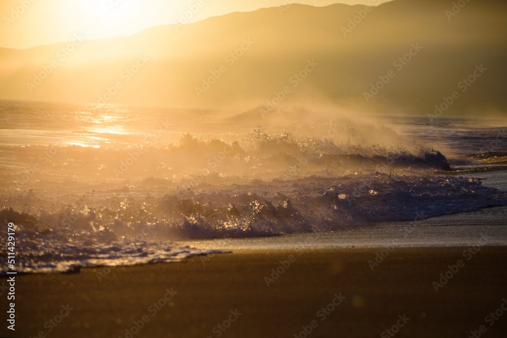 Fototapeta premium Sunrise background. Golden sunrise sunset over the sea waves. Sunrise over the ocean.