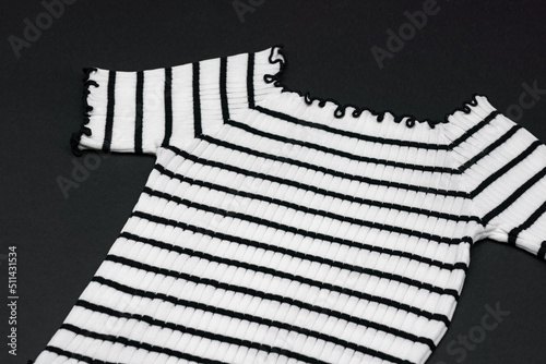 a frizzy knitwear tshit with horizontal black curve and curly line on clear background. photo