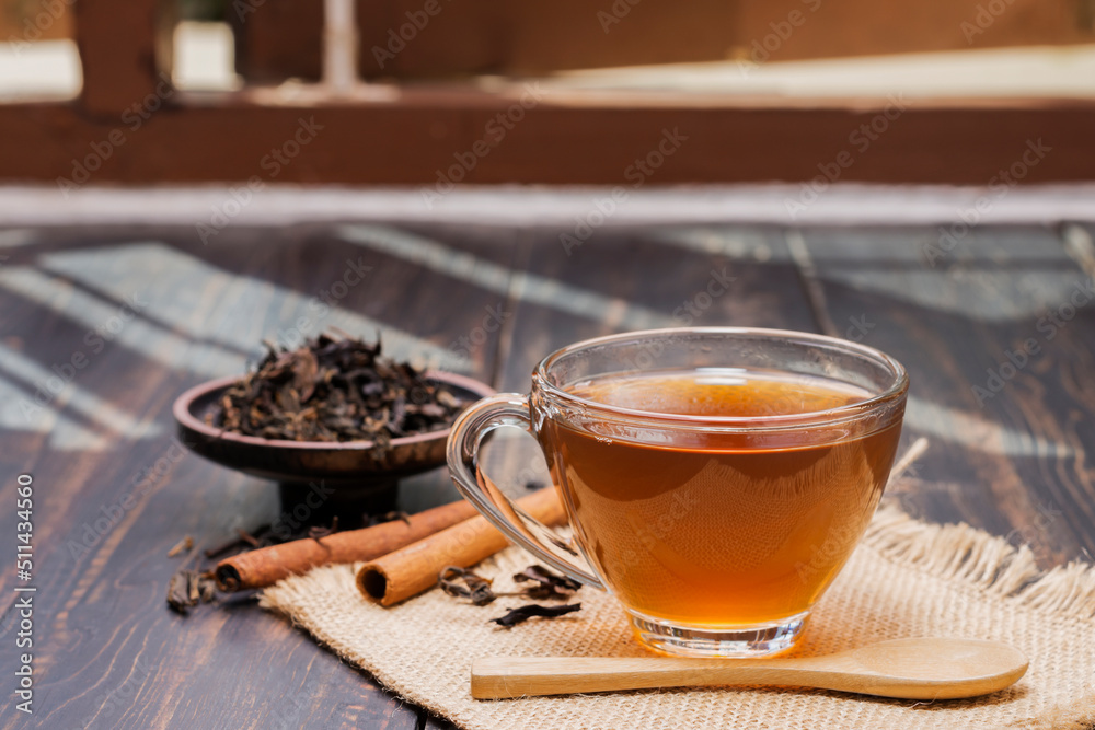 Close-up shot of a cup of hot tea or coffee placed on a desk or a table, drinking coffee by the window at work or at home, at sunset or in the morning. Close-up shot of a cup of hot tea or coffee placed on a desk or a table, drinking coffee by the window at work or at home, at sunset or in the morning.