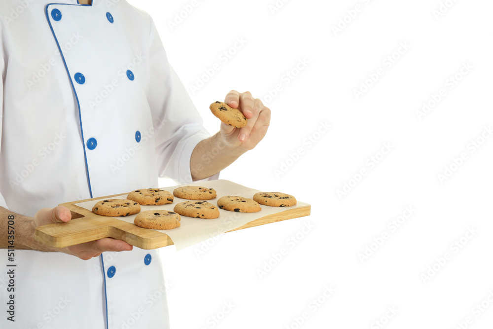 Young male chef with cookies isolated on white background Young male chef with cookies isolated on white background