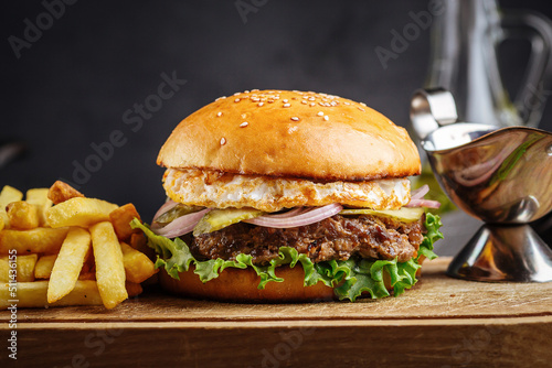 Closeup on burger set with french fries and sauce