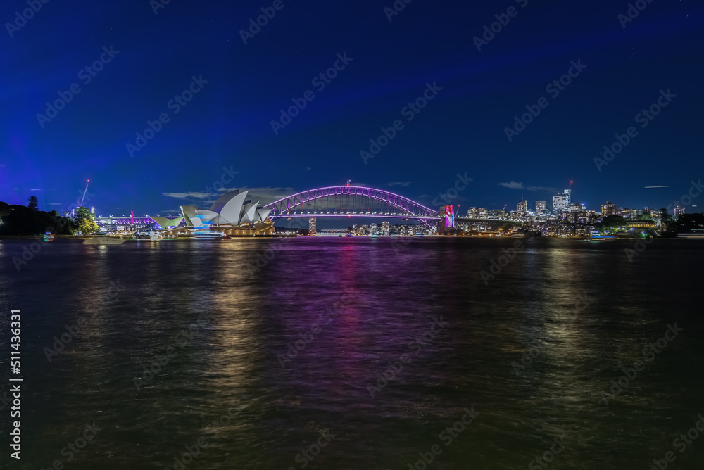 Colourful Light show at night on Sydney Harbour NSW Australia. The bridge illuminated with lasers and neon coloured lights. Sydney laser light show Colourful Light show at night on Sydney Harbour NSW Australia. The bridge illuminated with lasers and neon coloured lights. Sydney laser light show