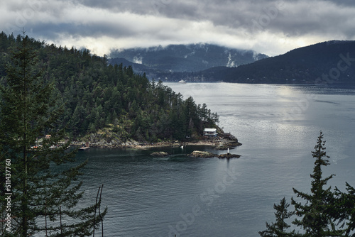 Dramatic view of the islands with the mountains in the clouds from the high point of view.
