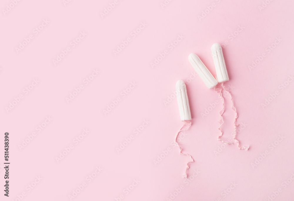 Menstrual tampons on a pink background. Menstruation time. Hygiene and protection for woman. Lack of feminine hygiene products