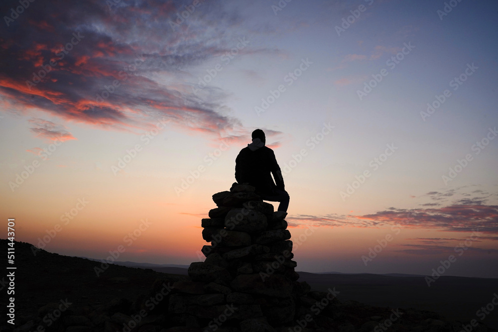 silhouette of a person on the top of the raks