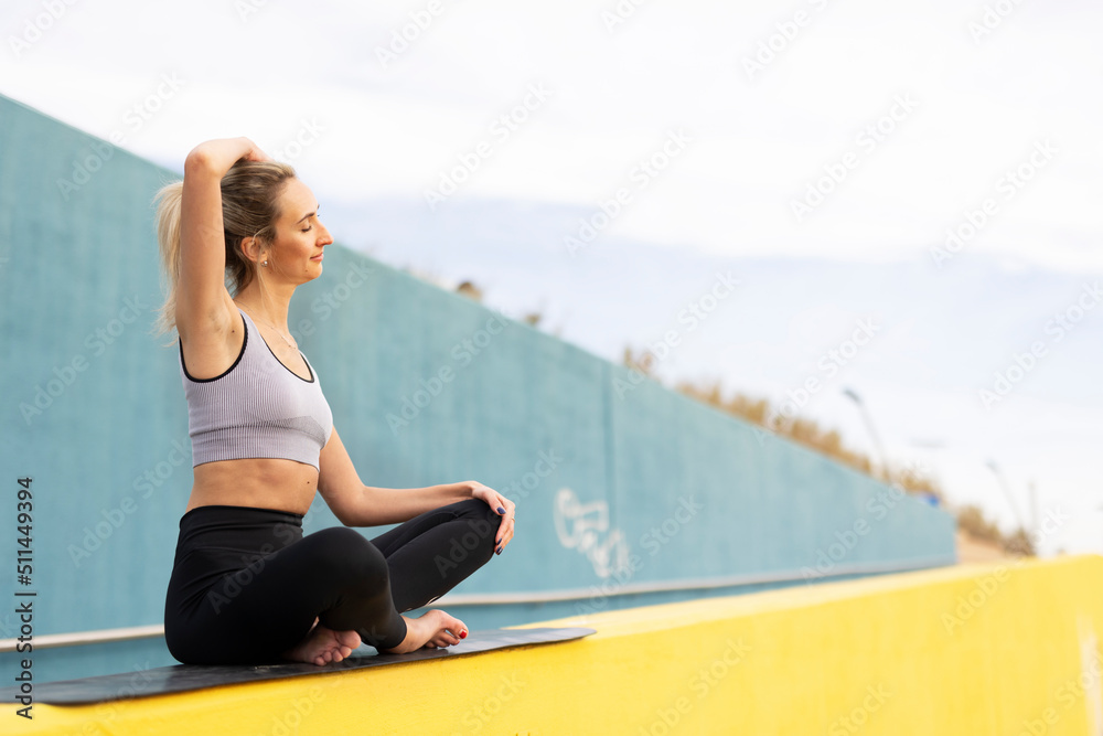 Young woman doing stretching exercise after running outside. Healthy lifestyle
