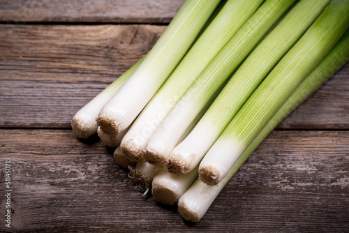 Baby leeks  on an old wood background