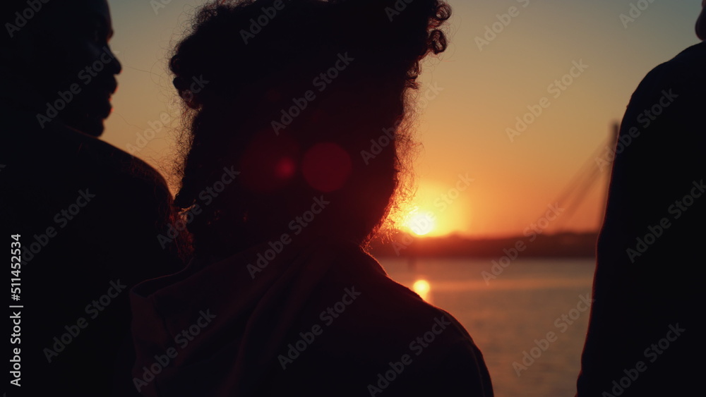 Curly girl silhouette standing with parents at golden sunset rear view closeup. Curly girl silhouette standing with parents at golden sunset rear view closeup.