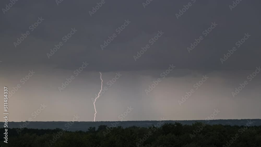 Lightning flash in storm clouds. Heavy clouds bring multiple flashes of