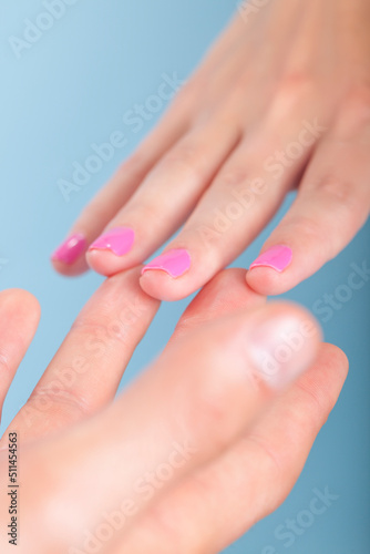 Tip of Fingers are Touching Each Other Against Blue Background