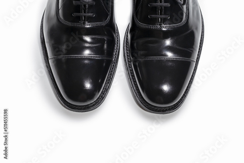 Footwear Concept. Closeup of Pair of Stylish Classic Formal Male Stylish Black Polished Oxford Leather Laced Shoes Placed Together Over White.