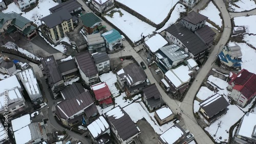 aerial top down of cars in japan driving through nozawa onsen village in nagano japan during winter photo