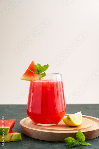 Watermelon drink, juice, lemonade with lemon and fresh mint leaves. Refreshing summer drink. DEtox healthy beverage, watermelon smoothie. photo
