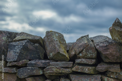 dry stone wall against blue sky. © martina87
