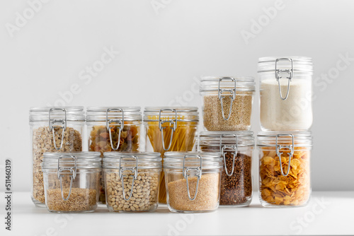 food, culinary and storage concept - jars with different cereals, pasta, beans a Fototapet