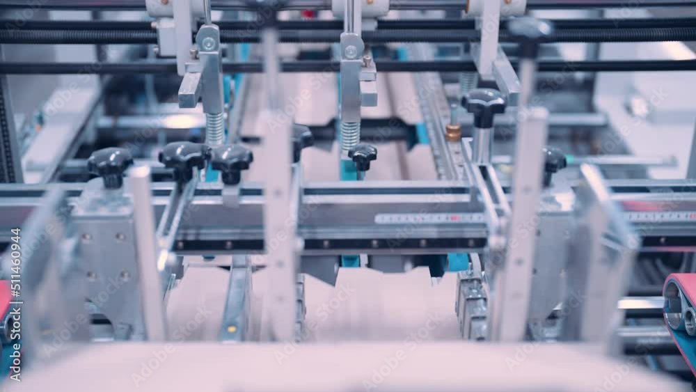 Close up, Automatic line for printing and cutting in the printing house.