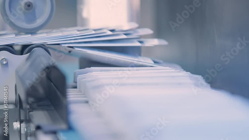 Close up, Automatic line for printing in the printing house.