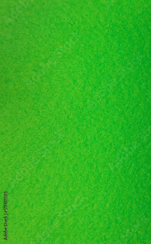 Green felt fabric close-up. Abstract background. The texture of the fibers. Velvet surface.