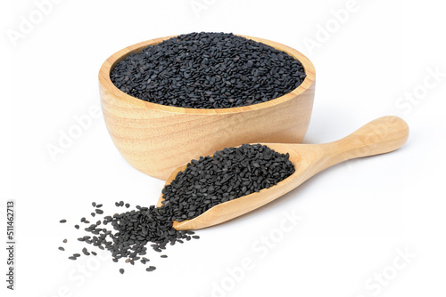 Black sesame seeds in wooden bowl and scoop isolated on white background.