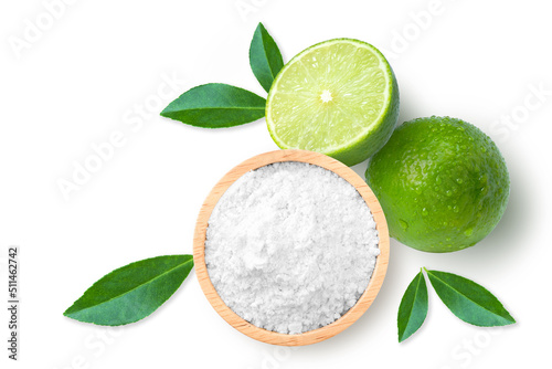 Lime powder in wooden bowl and fresh limes fruit isolated on white background. Top view. Flat lay. photo