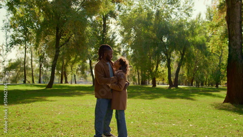 Father hugging daughter in sunny autumn park. Emotional connection child dad.