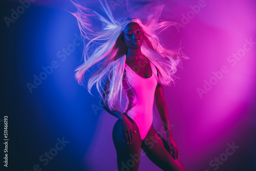 Photo of alluring appealing girl relaxing at disco club surrounded by fluorescent illumination background