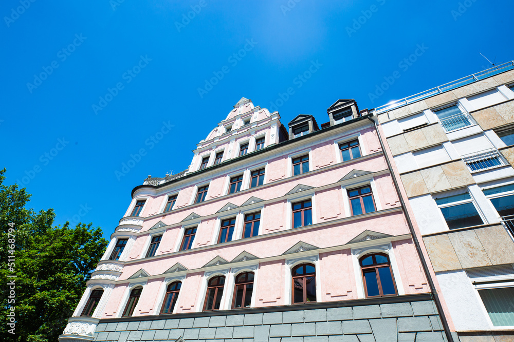 Fototapeta premium Rows of houses, apartment buildings, condominiums in Schwabing, blue sky