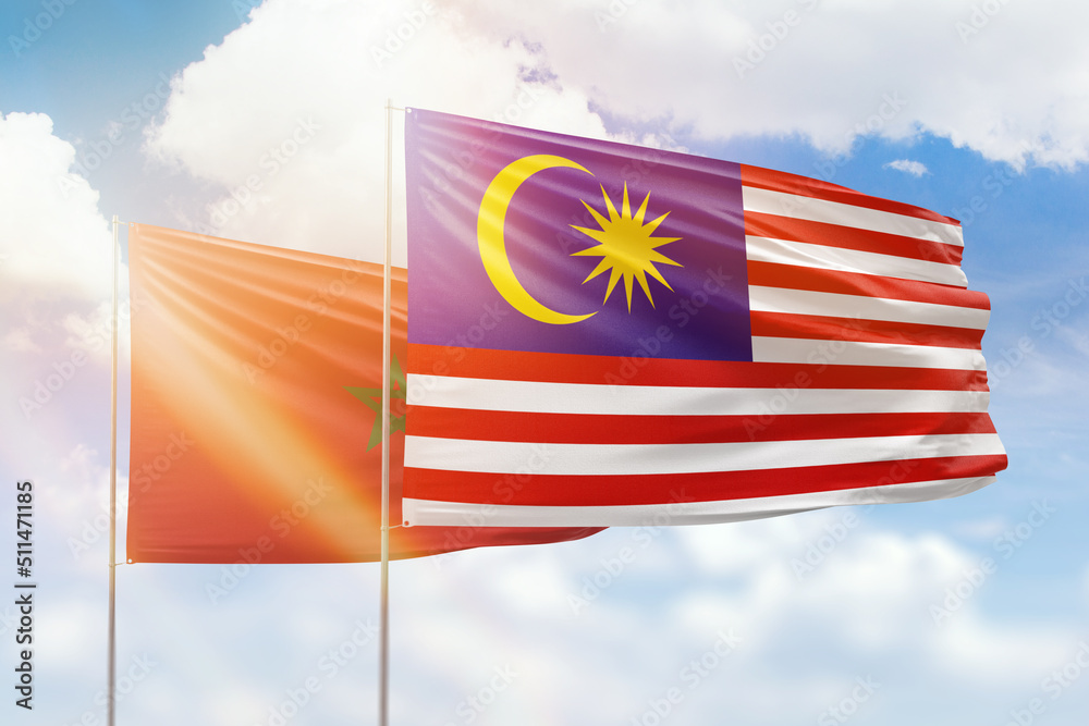 Sunny blue sky and flags of malaysia and morocco Sunny blue sky and flags of malaysia and morocco