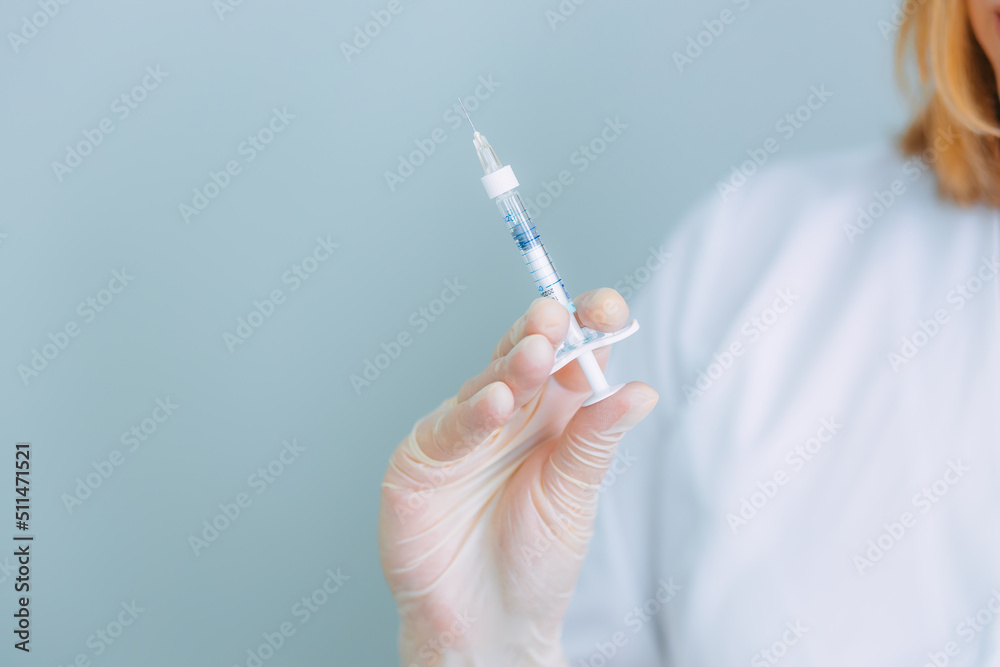 The doctor holds a syringe for vaccination or injection. The doctor holds a syringe for vaccination or injection.