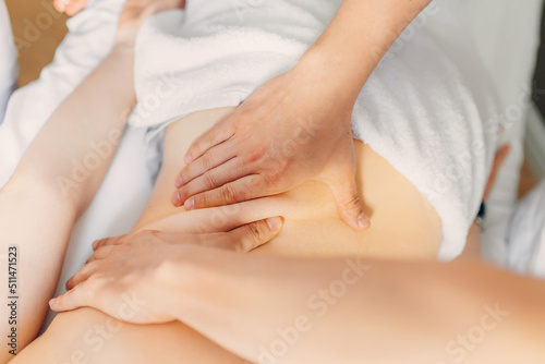 Young woman getting a back massage at the spa. Female patient being treated by an occupational therapist