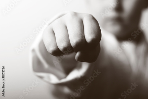 A young karate boy. Punch closeup