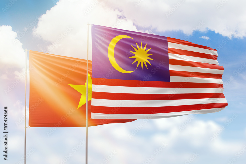 Sunny blue sky and flags of malaysia and vietnam Sunny blue sky and flags of malaysia and vietnam