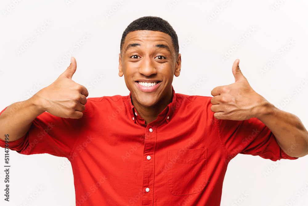 Like, excellent job. Pleased man smiling to camera and gesturing thumbs up, approval hand sign, satisfied with result. Indoor studio shot isolated on white background Like, excellent job. Pleased man smiling to camera and gesturing thumbs up, approval hand sign, satisfied with result. Indoor studio shot isolated on white background