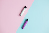 Modern disposable electronic cigarettes on color background