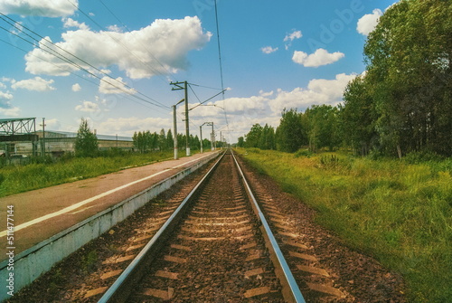 Railway tracks tend to the horizon and the sky