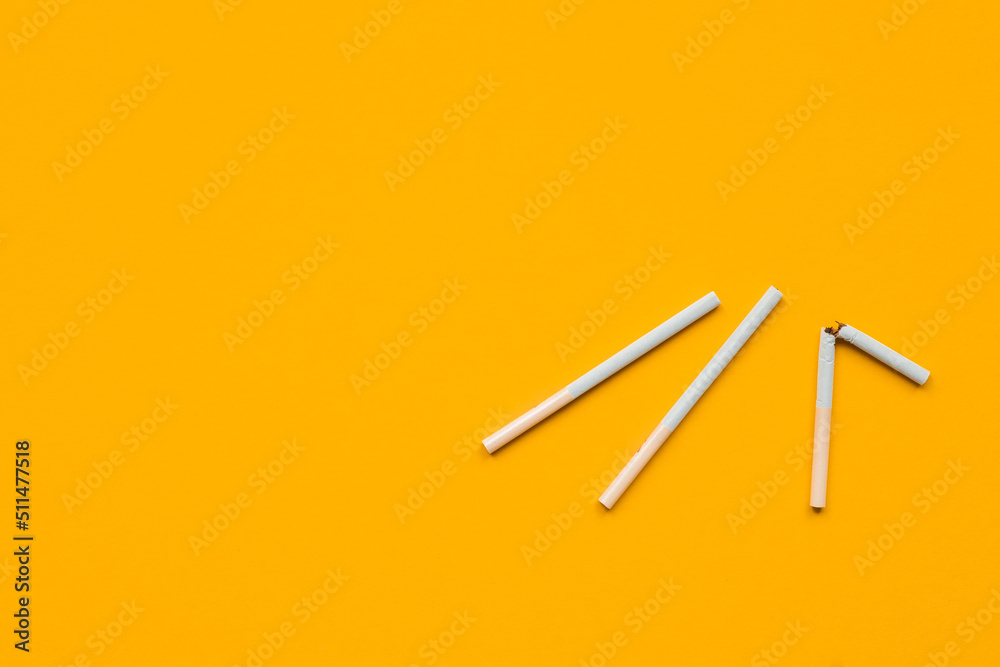 Close up of a smoking cigarettes on color background. No smoking concept