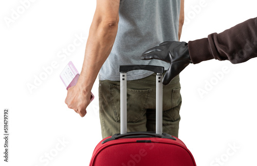 Photo Rear view of a hand of a thief stealing a suitcase in the lobby of airport