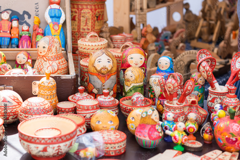 Russian folk toys made of wood. Nesting dolls of different types. Wooden items. utensils for playing. Festival of Nationalities and Religions.
