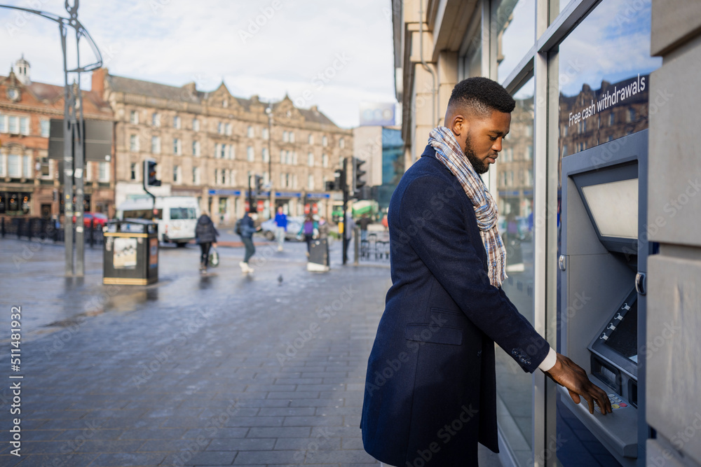 Side View of Man Wearing Scarf Using Cash Point Stock Photo | Adobe Stock