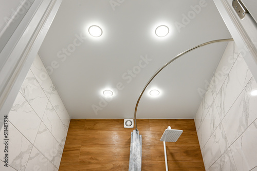 Stretch ceiling in the bathroom with built-in lighting. photo